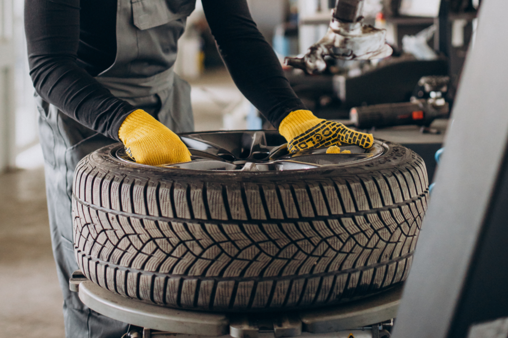 A luxurious car is cruising smoothly on a pristine road, symbolizing the excellence and quality associated with New Cochin Tyres. The image reflects the commitment to unparalleled service and quality for vehicles