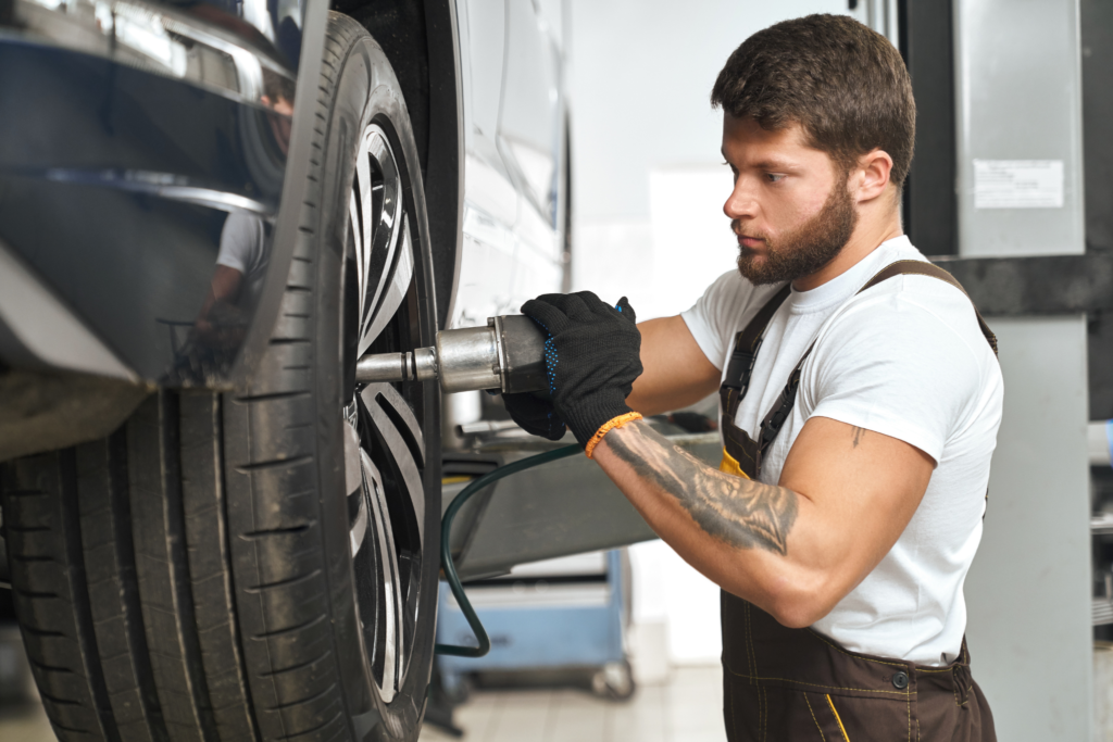 Technicians at New Cochin Tyres work on vehicles to ensure optimal performance and safety. The well-equipped tire service center promises a smooth journey ahead for customers.