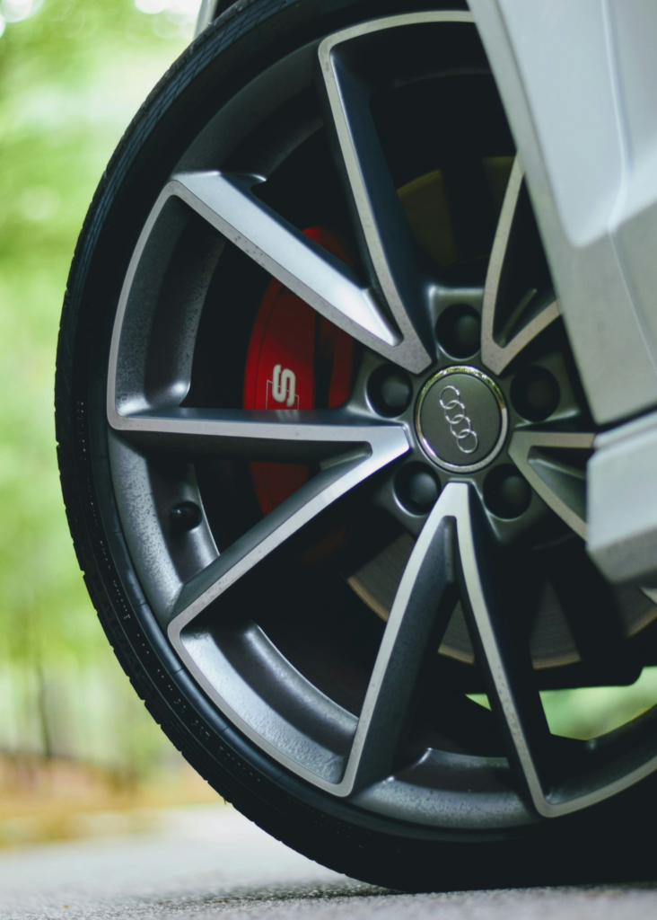 A customer service representative assisting a satisfied customer with selecting tires at New Cochin Tyres. The vibrant atmosphere of the tire showroom reflects the commitment to unmatched service and top-notch quality.